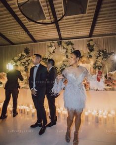 a man and woman standing next to each other in front of candles