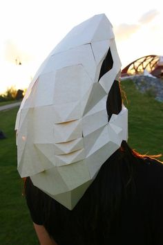 a person with a paper mask on their head