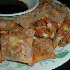 some food on a plate with dipping sauce