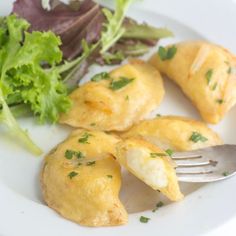 a white plate topped with food and a fork