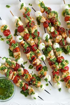 several skewers filled with meat and veggies on top of a white plate