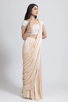 Cream pre-draped saree in satin base. Comes with a crepe padded blouse with sequins, cutdana and thread hand embroidery. - Aza Fashions Designer Silk Draped Saree, Designer Draped Art Silk Blouse Piece, Draped Art Silk Blouse For Designer Wear, Silk Draped Lehenga For Designer Wear, Art Silk Draped Saree For Reception, Designer Silk Pre-draped Saree With Draped Sleeves, Designer Pre-draped Art Silk Saree, Draped Art Silk Lehenga For Reception, Designer Wear Pre-draped Art Silk Saree