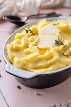 mashed potatoes with butter and parmesan cheese in a dish on a table