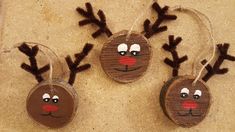 three wooden ornaments with reindeer faces on them