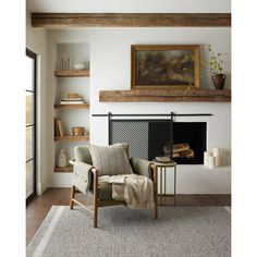 a living room filled with furniture and a fire place next to a wall mounted painting