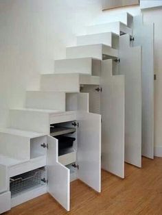 the stairs are built into the wall with drawers