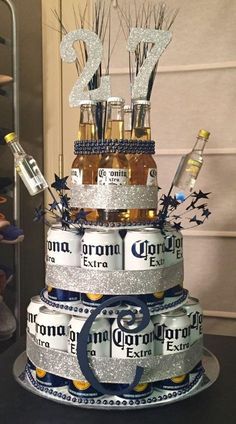 a cake made to look like it is stacked with beer bottles and decorated with glitter