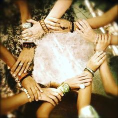 a group of people with their hands together