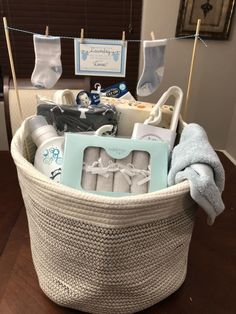 a basket filled with baby items sitting on top of a wooden table