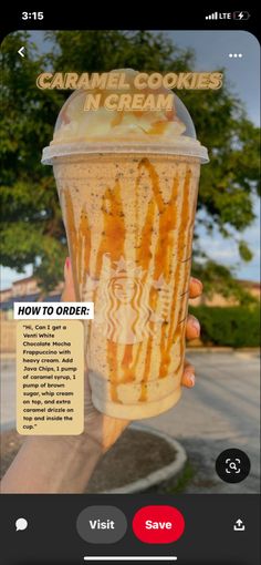 someone holding up a cup with caramel cookies and cream on it in front of the camera