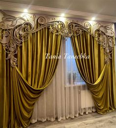 the curtains are open and ready to be hung in front of the window with gold drapes