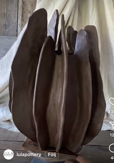 a person is holding up a chocolate sculpture