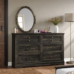 a bedroom with a dresser and mirror in it