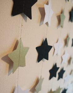 the stars are hanging from the string on the wall