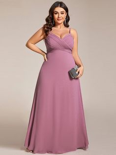 a woman in a long purple dress posing for the camera with her hand on her hip