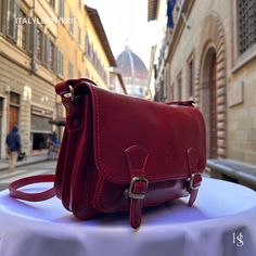 This bag has been made of the best genuine leather by local master crafters of Florence in Italy, designed for women who only accept premium Italian quality and luxury leather bags and modern Italian fashion. . . . Sizes: Width:   27 cm/10.75 inch Height:  18 cm/7 inch Depth:    11 cm/4.25 inch The story of this bag: Alessandro was on a mission to find the perfect gift for his girlfriend's upcoming anniversary. He wanted to surprise her with something special, something that would show her how much he cared. He knew she loved fashion and always admired the beautiful leather bags made in Florence. He thought it would be the perfect gift, but with so many options to choose from, he was feeling overwhelmed. He scoured the shops, but couldn't seem to find the right one. One day, he stumbled up Elegant Red Leather Saddle Bag, Classic Red Flap Bag, Red Saddle Bag For Formal Occasions, Luxury Red Leather Saddle Bag, Red Leather-lined Satchel For Business, Luxury Red Saddle Shoulder Bag, Red Leather Saddle Bag With Detachable Strap, Red Business Bag With Smooth Grain, Classic Red Leather Satchel