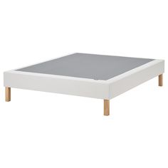 a white bed frame with wooden legs and grey mattress pad on the bottom half of it