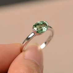 This is a gorgeous handmade creation. Its beauty is its simplicity & Elegance. The 6*8mm round cut lab green sapphire is crafted in solid sterling silver and with rhodium plated. All item is sent in a beautiful gift box You can realize more lovely stuff clicking the link https://www.etsy.com/shop/knightjewelry?refshopsection_shophome_leftnav Please leave the correct address and you phone number for delivering successfully. Green Sapphire Ring For May Birthstone In Sterling Silver, Green Sapphire Sterling Silver Ring For May Birthstone, Green Sapphire Ring Sterling Silver, May Birthstone, Modern Emerald Ring With Birthstone, Modern Emerald Birthstone Ring, Green Sterling Silver Round Cut Birthstone Ring, Green Round Cut Sterling Silver Birthstone Ring, Green Sterling Silver Birthstone Ring Round Cut, Green Solitaire Sapphire Ring In Sterling Silver