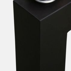 an alarm clock sitting on top of a black stand