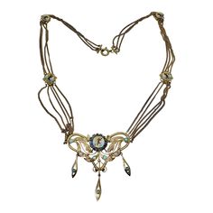 This is a very rare antique museum quality Egyptian Revival Necklace in Gold with Sapphires, Turquoise and Pearls with magnificent enamel work depicting images of the Pharoah or Goddess, or Nefertiti or Cleopatra. The elegant four strand festoon motif necklace has a large pendant drop at the bottom with a central enamel medallion of the Pharaoh. The image is surrounded by a halo of blue Sapphires. The pendant is further adorned with Turquoise cabochons as well as Pearls. The pendant has three el Antique Yellow Gold Necklace With Cabochon, Victorian Jeweled Pendant Necklace, Antique Multi-stone Pendant Necklace, Antique Gold Cabochon Necklace, Antique Gold Multi-stone Necklace, Antique Hallmarked Turquoise Jewelry, Victorian Hallmarked Turquoise Jewelry, Victorian Turquoise Hallmarked Jewelry, Antique Gold Necklace With Cabochon