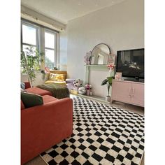 a living room filled with furniture and a flat screen tv