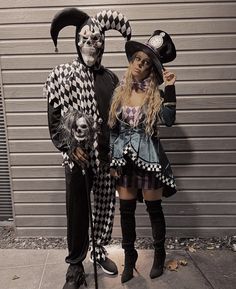 two people dressed up in costumes standing next to each other