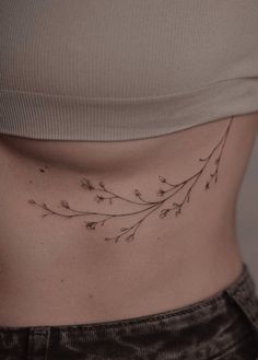 a woman's stomach with small flowers on it