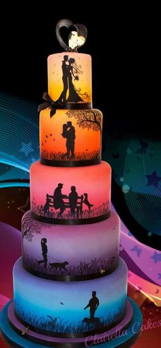 a multi layer cake with silhouettes of people on it