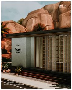 the outside of a building with plants and rocks in the background