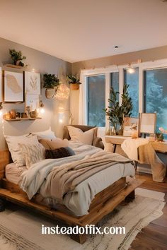 a bed sitting in a bedroom next to two windows with lights on them and plants