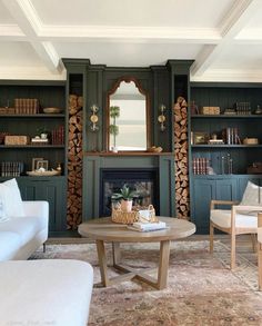 a living room filled with furniture and a fire place in front of a book shelf