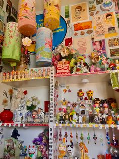 shelves filled with lots of different types of toys and decorations on top of each other