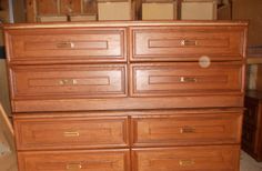 a large wooden dresser sitting on top of a floor next to a pile of boxes