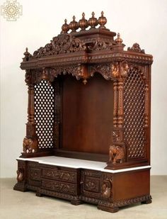 an ornate wooden bed with carved carvings on it