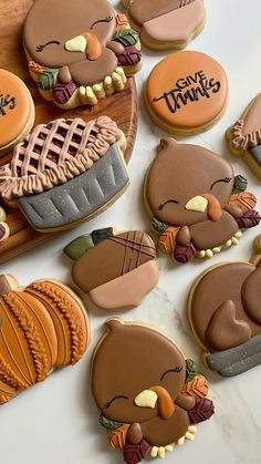 decorated cookies are arranged in the shape of turkeys and pies on a table