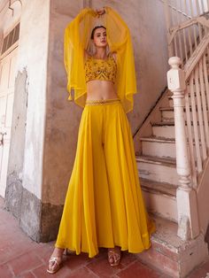 Introducing our stunning yellow embroidered georgette crop top palazzo with a matching strug, the perfect ensemble for any special occasion. This fully stitched outfit is available in sizes S to L, ensuring a comfortable and flattering fit for all body types. The bright yellow color exudes vibrancy and style, making it a standout choice for events, functions, parties, and more.
The georgette fabric is lightweight and flowy, perfect for twirling on the dance floor or making a grand entrance. The Yellow Sharara, Designer Crop Top, Embellished Crop Top, Crop Top Style, Lehenga Choli Wedding, Bollywood Lehenga, Georgette Dupatta, Bespoke Clothing, Crop Top Designs