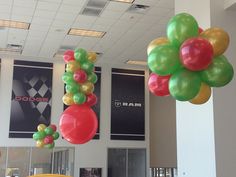 some balloons are hanging from the ceiling in an office