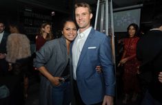 a man and woman standing next to each other at an event