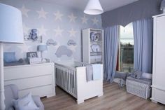 a baby's room with blue and white decor