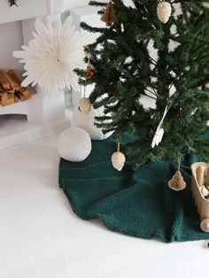 a small christmas tree with ornaments hanging from it