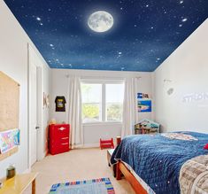 a child's bedroom decorated in blue and white with stars on the ceiling, along with a full size bed