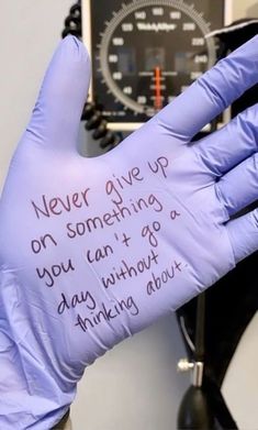 a glove with writing on it that says never give up on something you can't go through