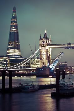 the tower bridge is lit up at night