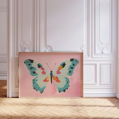 a pink and blue butterfly painting on a wall in an empty room with white walls