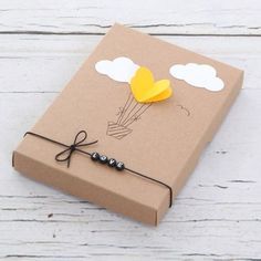 a brown box with some yellow balloons on it