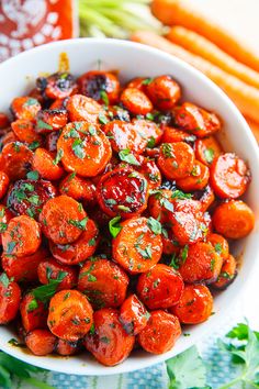 a white bowl filled with carrots on top of a table