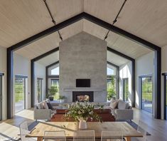 a living room filled with furniture and a fire place in the middle of a room