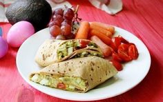 an egg, carrots, and other food items are on a plate next to some eggs