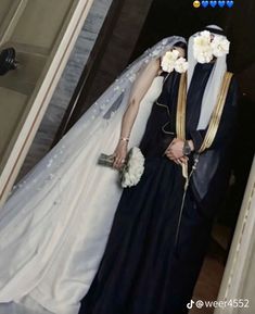 a man and woman dressed up in wedding attire standing next to each other with flowers on their heads