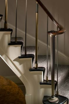 a set of stairs in a house with carpeted flooring and white railings